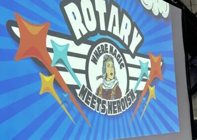 The evening's Rotary Meets Heroes theme on screen at the 2024 Foundation Dinner