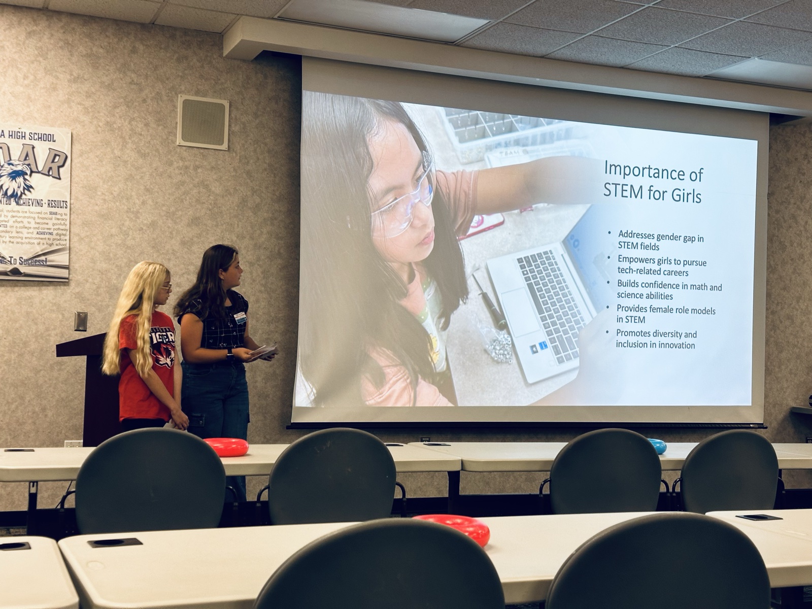 Two students presenting on the importance of STEM for girls