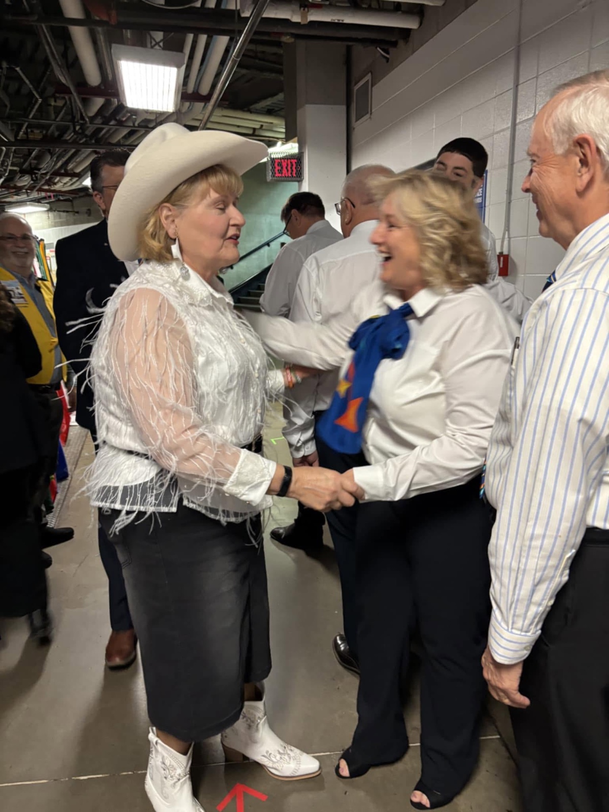 Judy Zulfiqar greets a fellow governor backstage at the 2025 Rotary International Convention