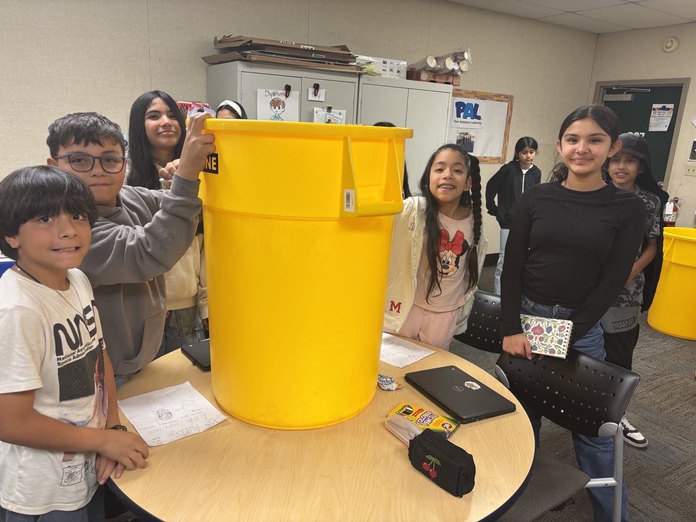 Mission Bell Elementary EarlyAct students preparing a recycling can together