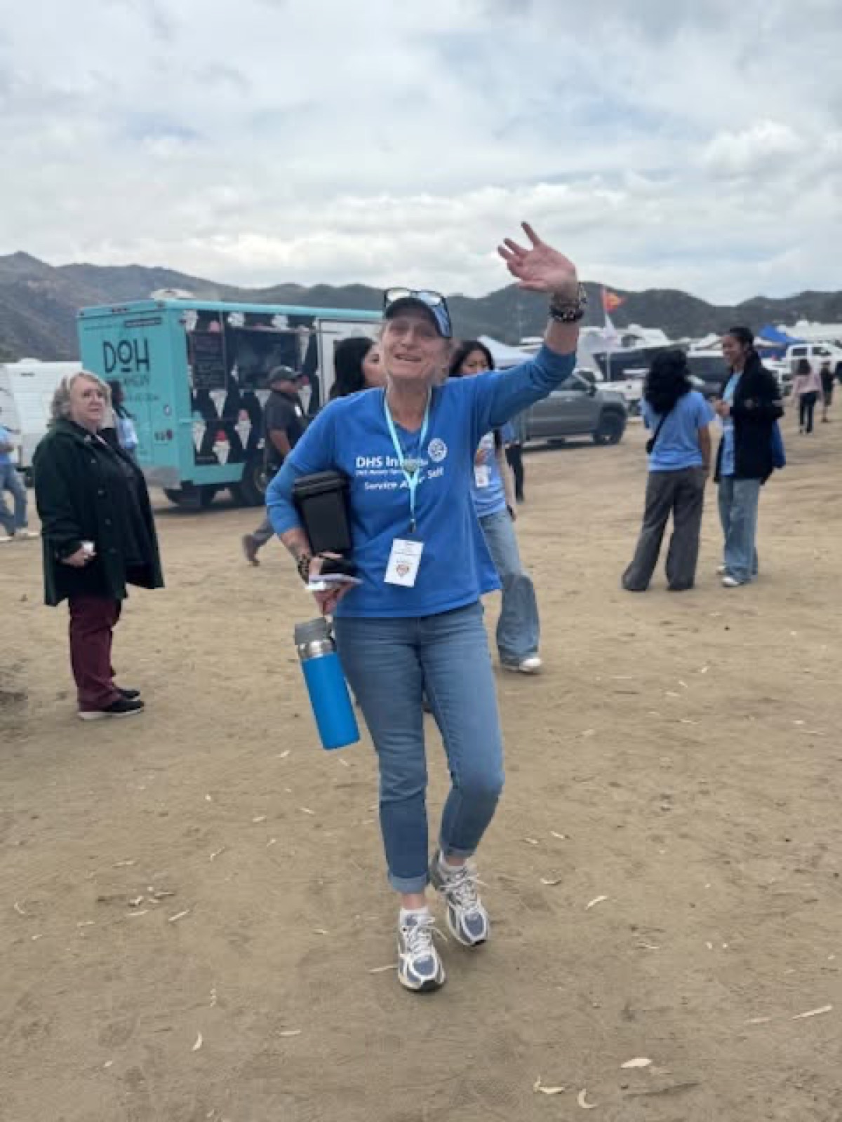 An Interact volunteer waves during the day of service at Galway