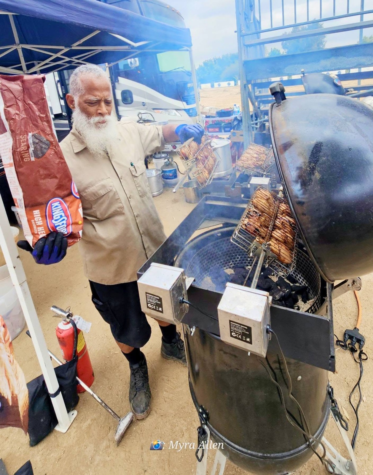 The pitmaster tends the grill at Rotary Day at Galway