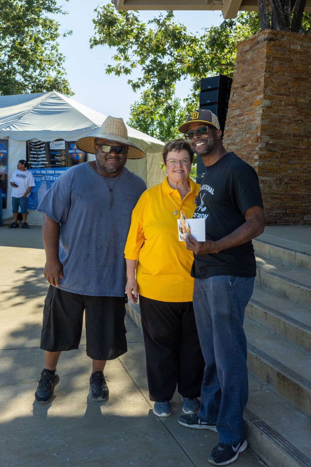 Rotary volunteers congratulate a BBQ competition team at the iGNITE Festival