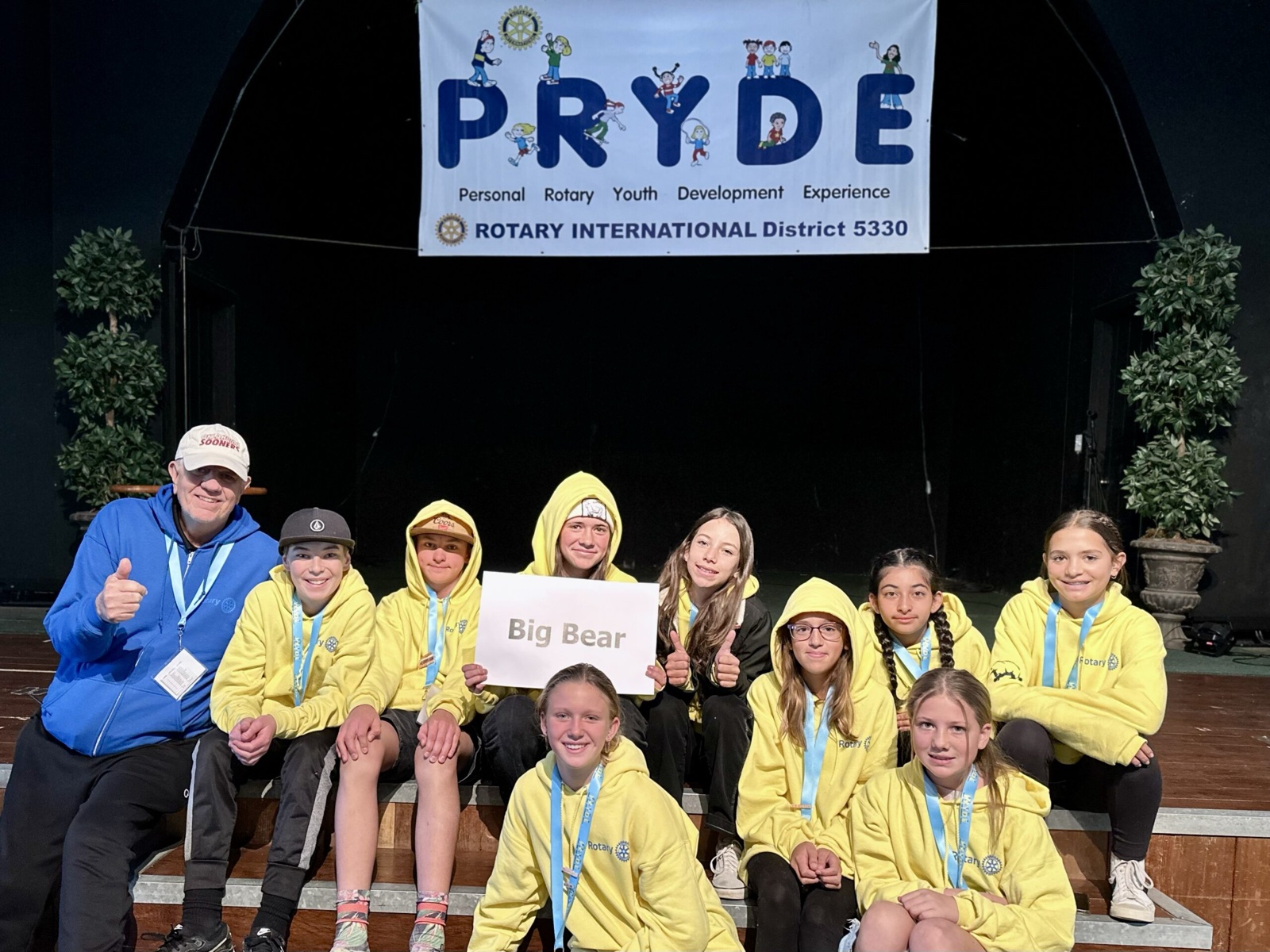 A sponsoring club's students at PRYDE 2023, under the PRYDE banner