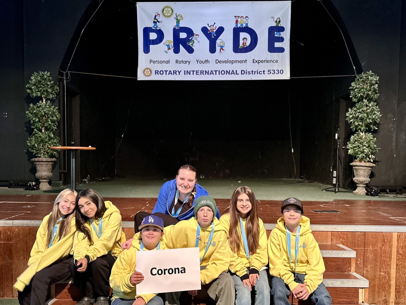 A sponsoring club's students at PRYDE 2023, under the PRYDE banner