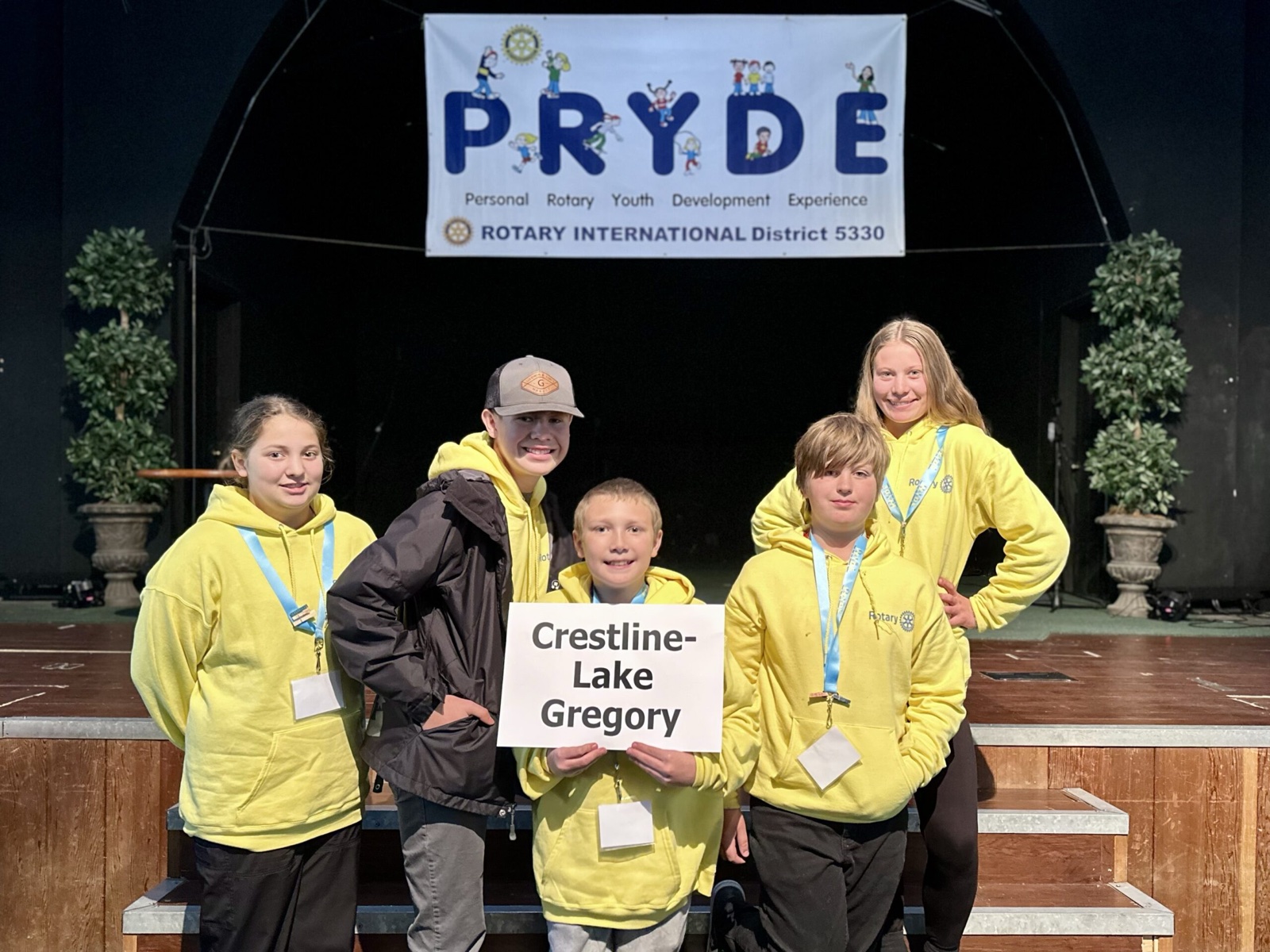 A sponsoring club's students at PRYDE 2023, under the PRYDE banner