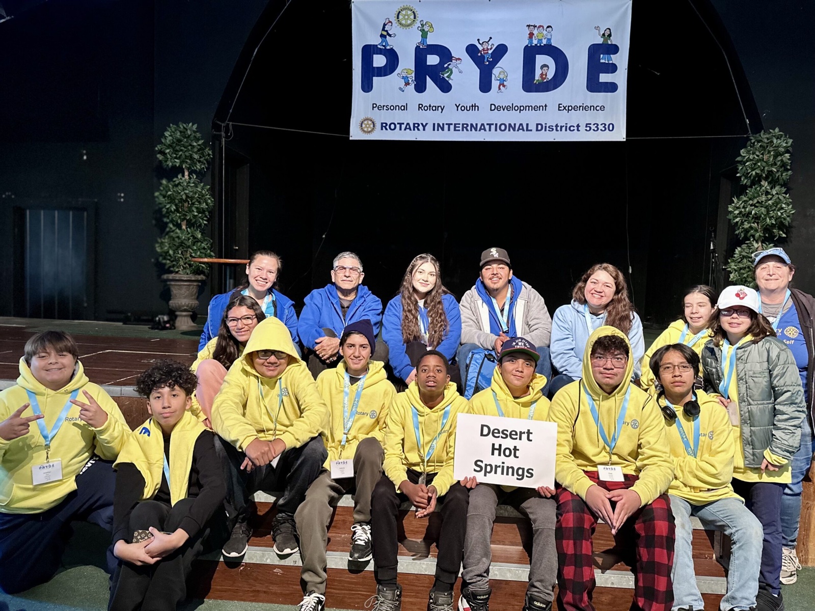 A sponsoring club's students at PRYDE 2023, under the PRYDE banner