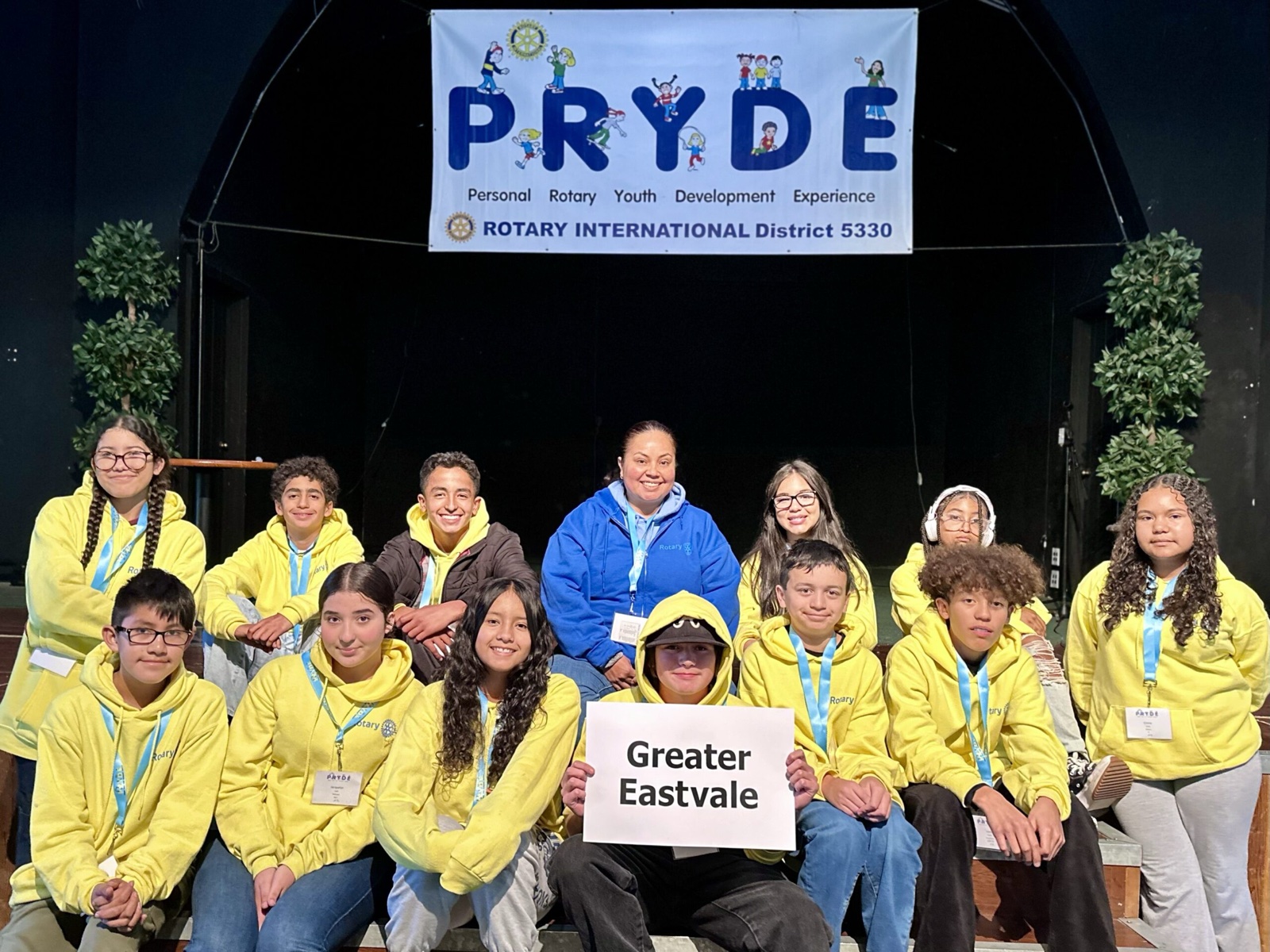 A sponsoring club's students at PRYDE 2023, under the PRYDE banner