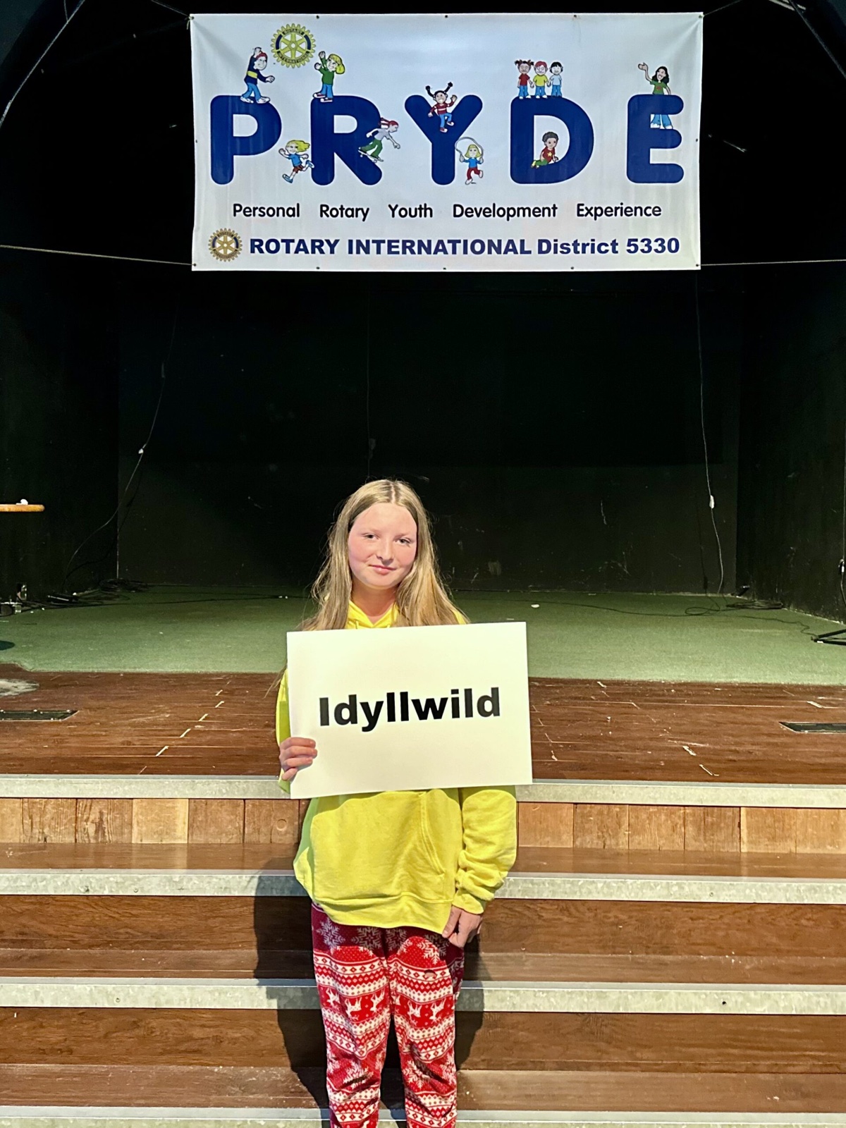 A sponsoring club's students at PRYDE 2023, under the PRYDE banner