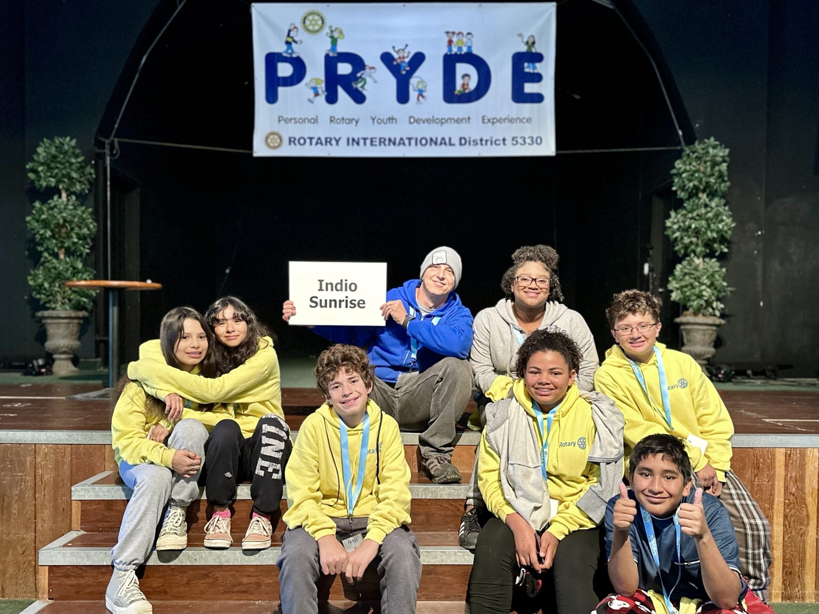 A sponsoring club's students at PRYDE 2023, under the PRYDE banner