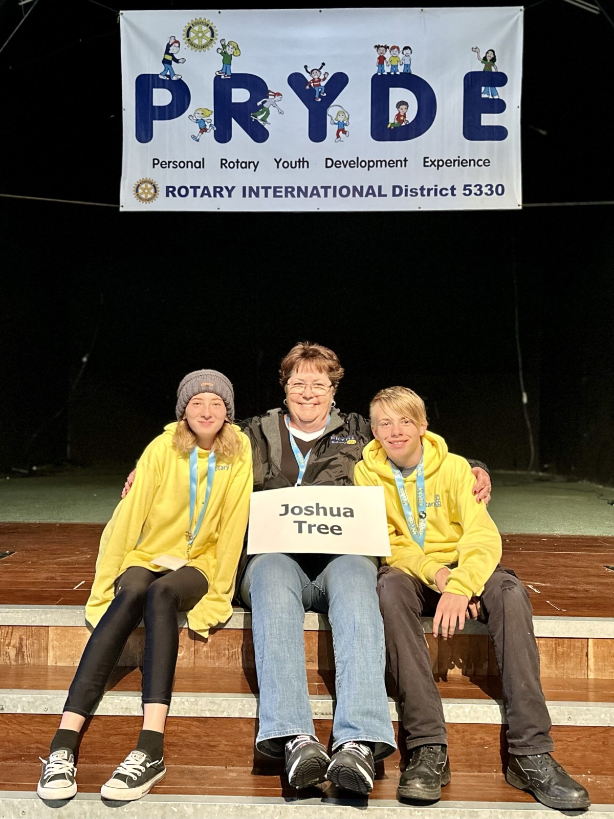 A sponsoring club's students at PRYDE 2023, under the PRYDE banner