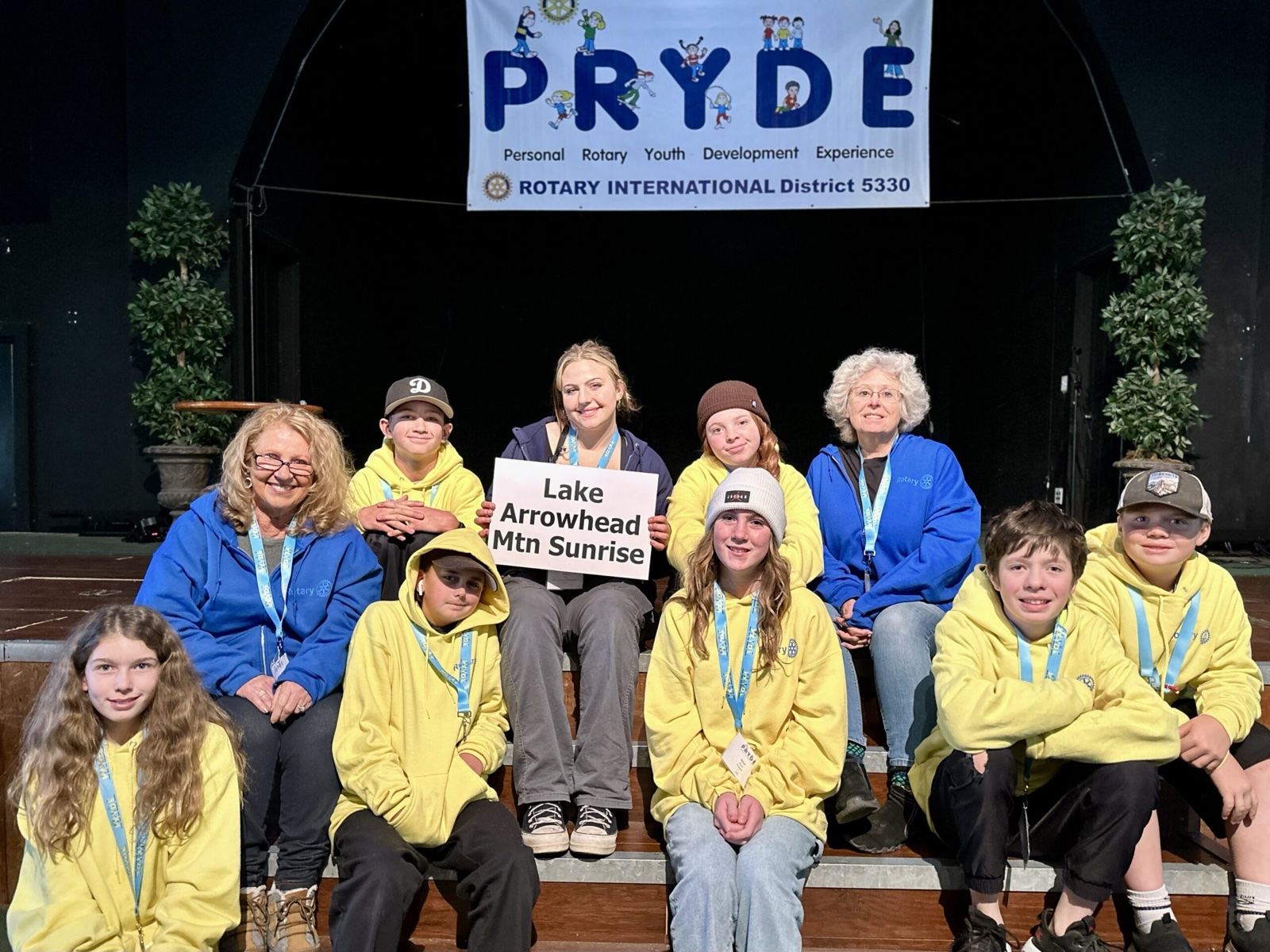 A sponsoring club's students at PRYDE 2023, under the PRYDE banner