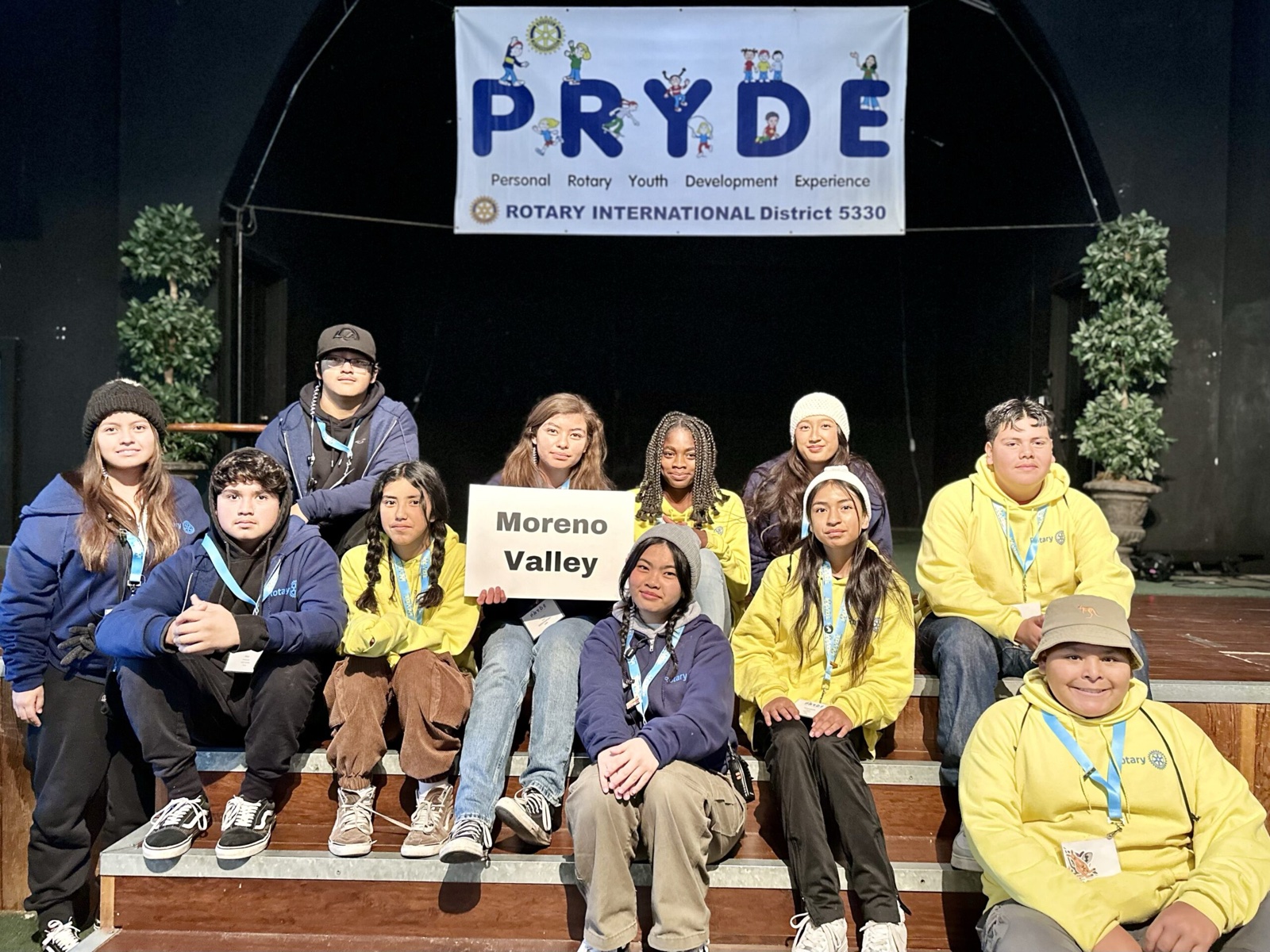 A sponsoring club's students at PRYDE 2023, under the PRYDE banner
