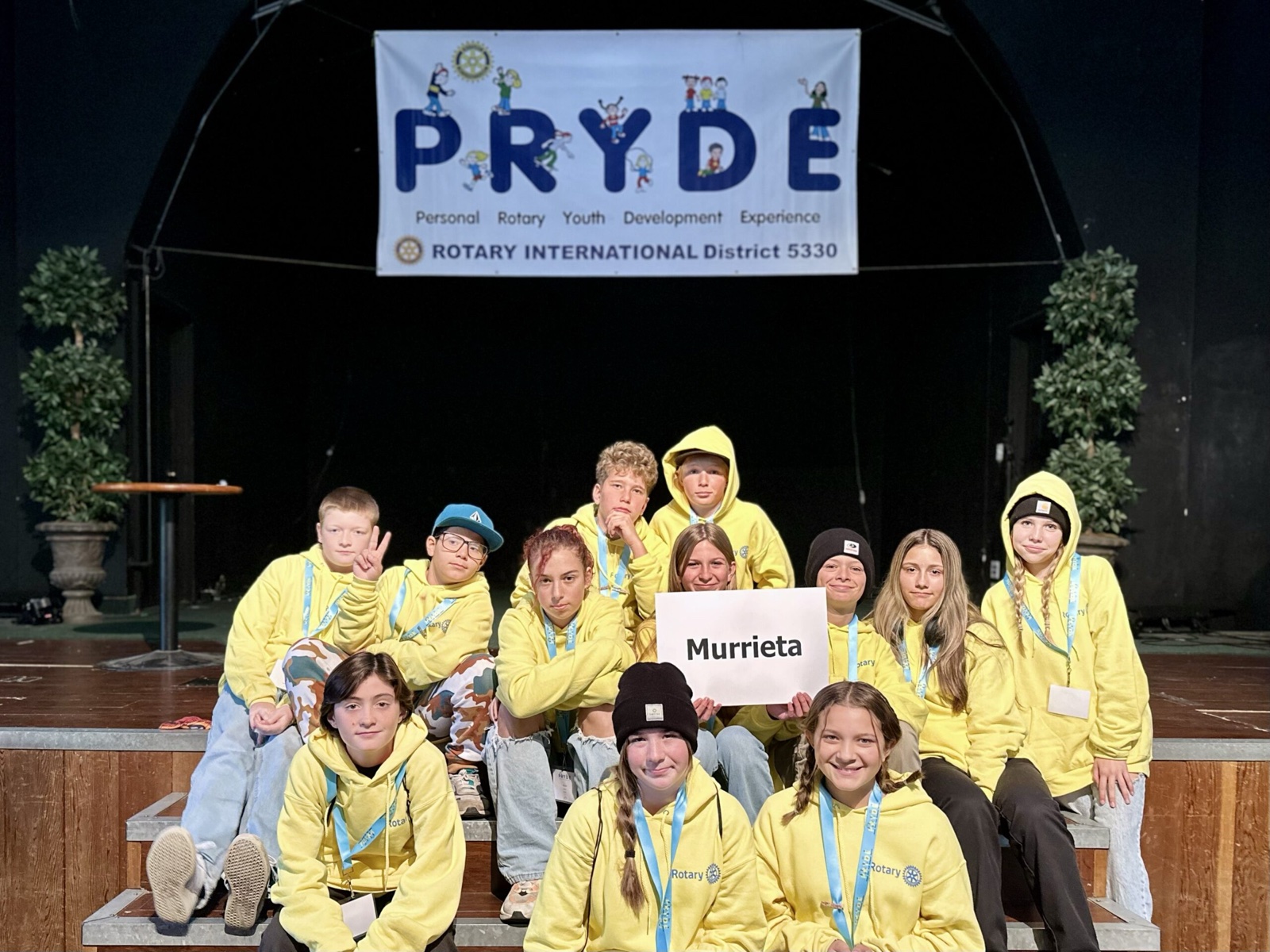 A sponsoring club's students at PRYDE 2023, under the PRYDE banner