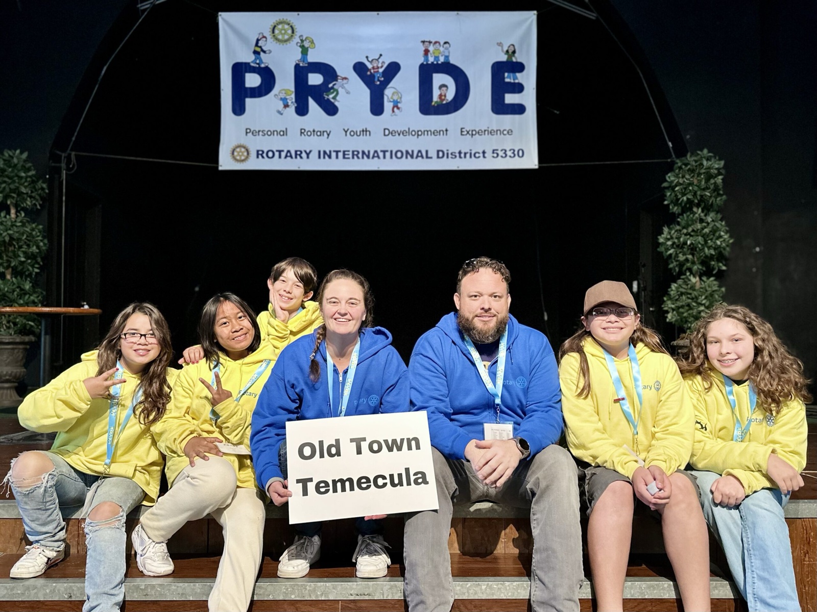A sponsoring club's students at PRYDE 2023, under the PRYDE banner