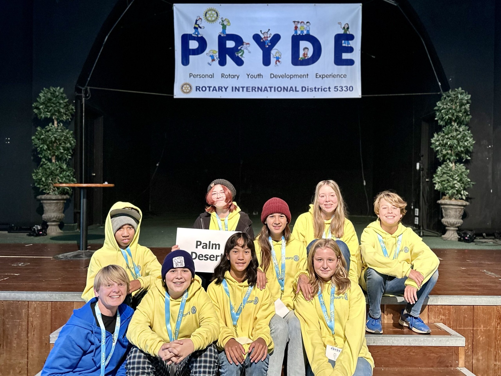 A sponsoring club's students at PRYDE 2023, under the PRYDE banner