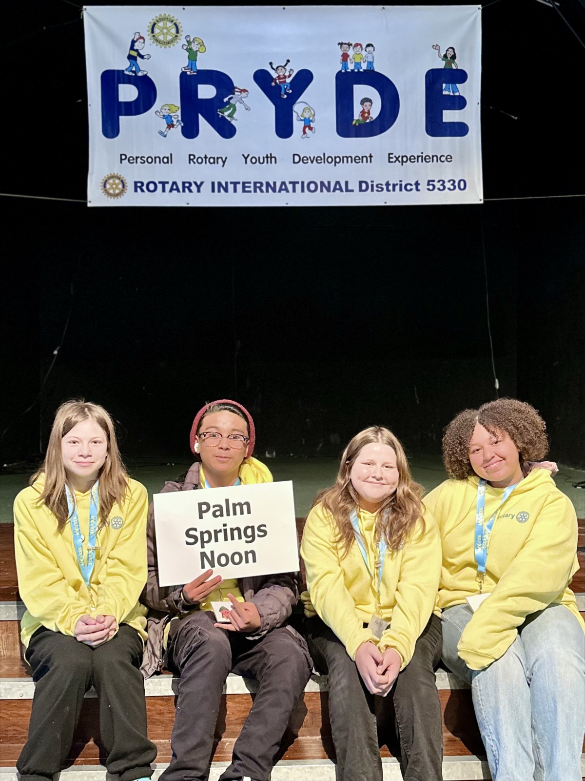 A sponsoring club's students at PRYDE 2023, under the PRYDE banner