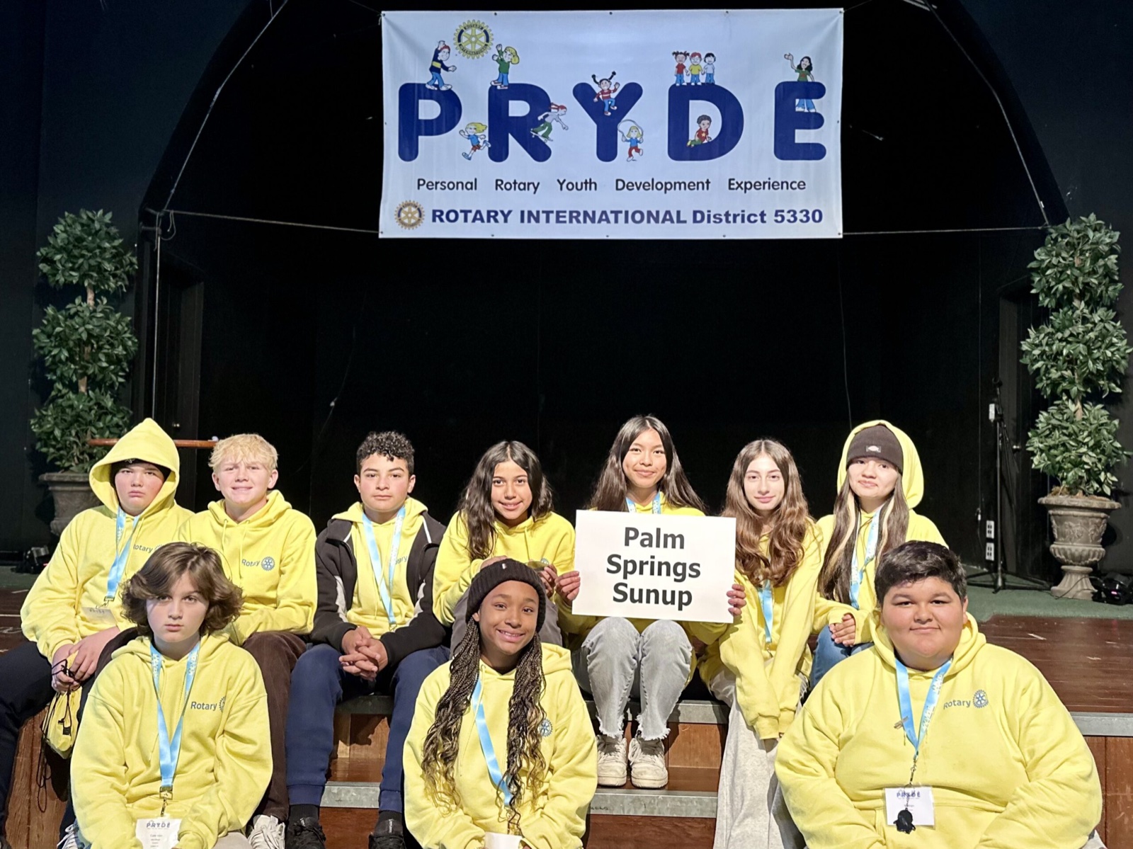 A sponsoring club's students at PRYDE 2023, under the PRYDE banner