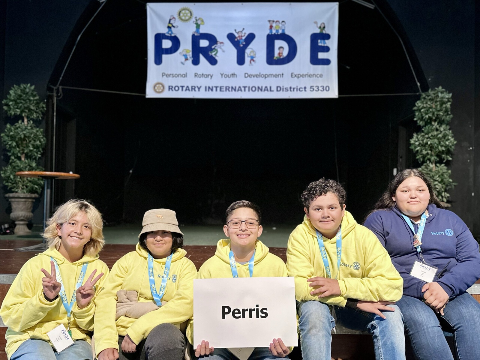 A sponsoring club's students at PRYDE 2023, under the PRYDE banner
