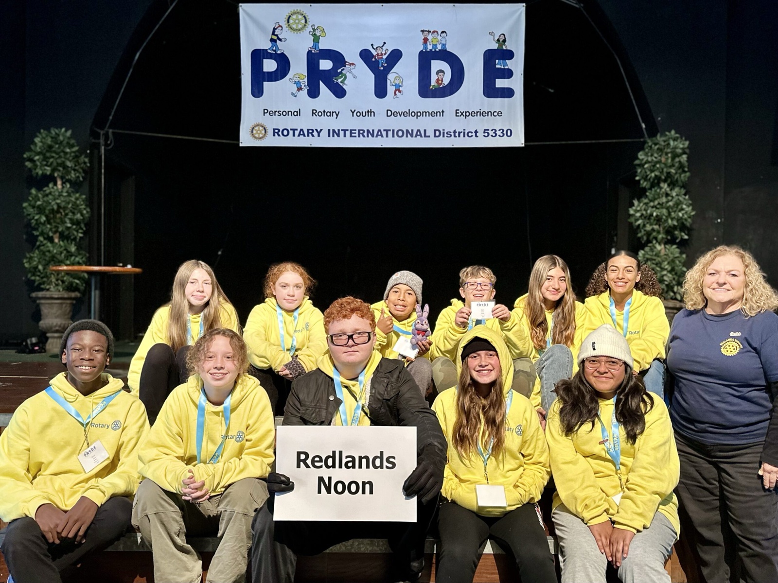 A sponsoring club's students at PRYDE 2023, under the PRYDE banner