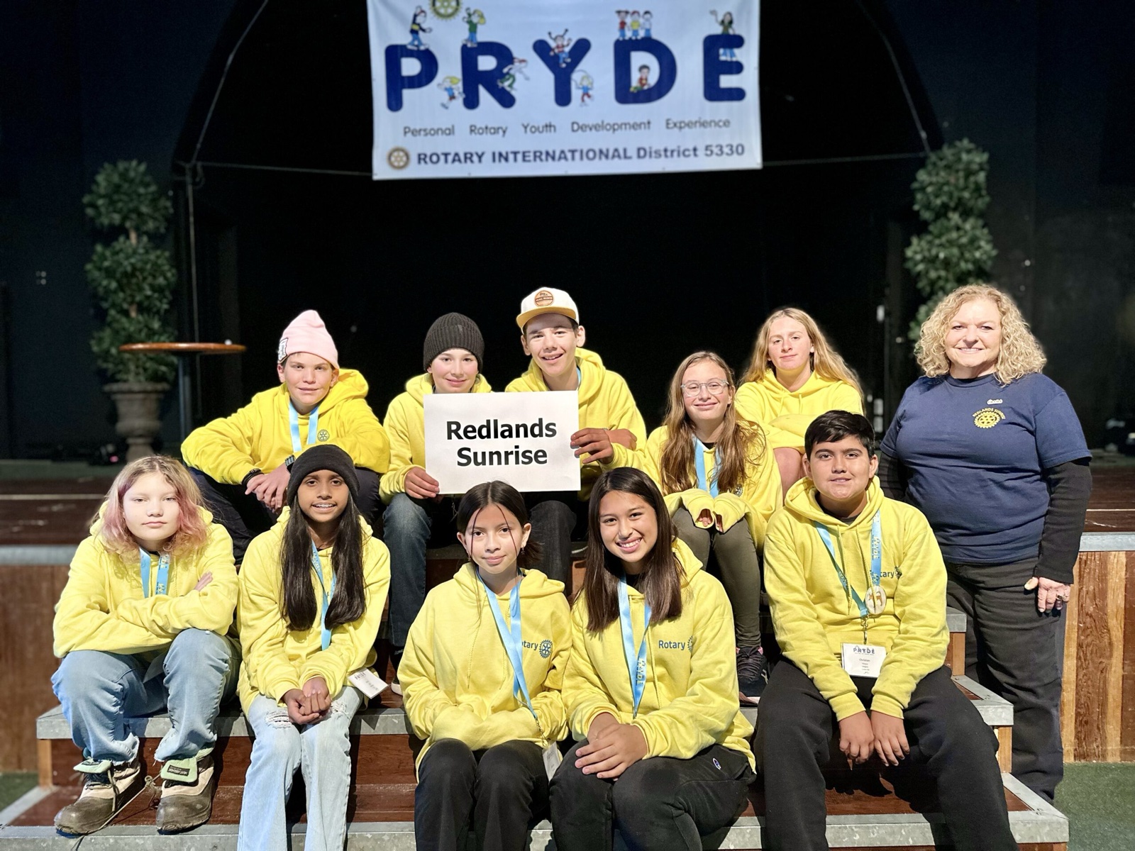 A sponsoring club's students at PRYDE 2023, under the PRYDE banner