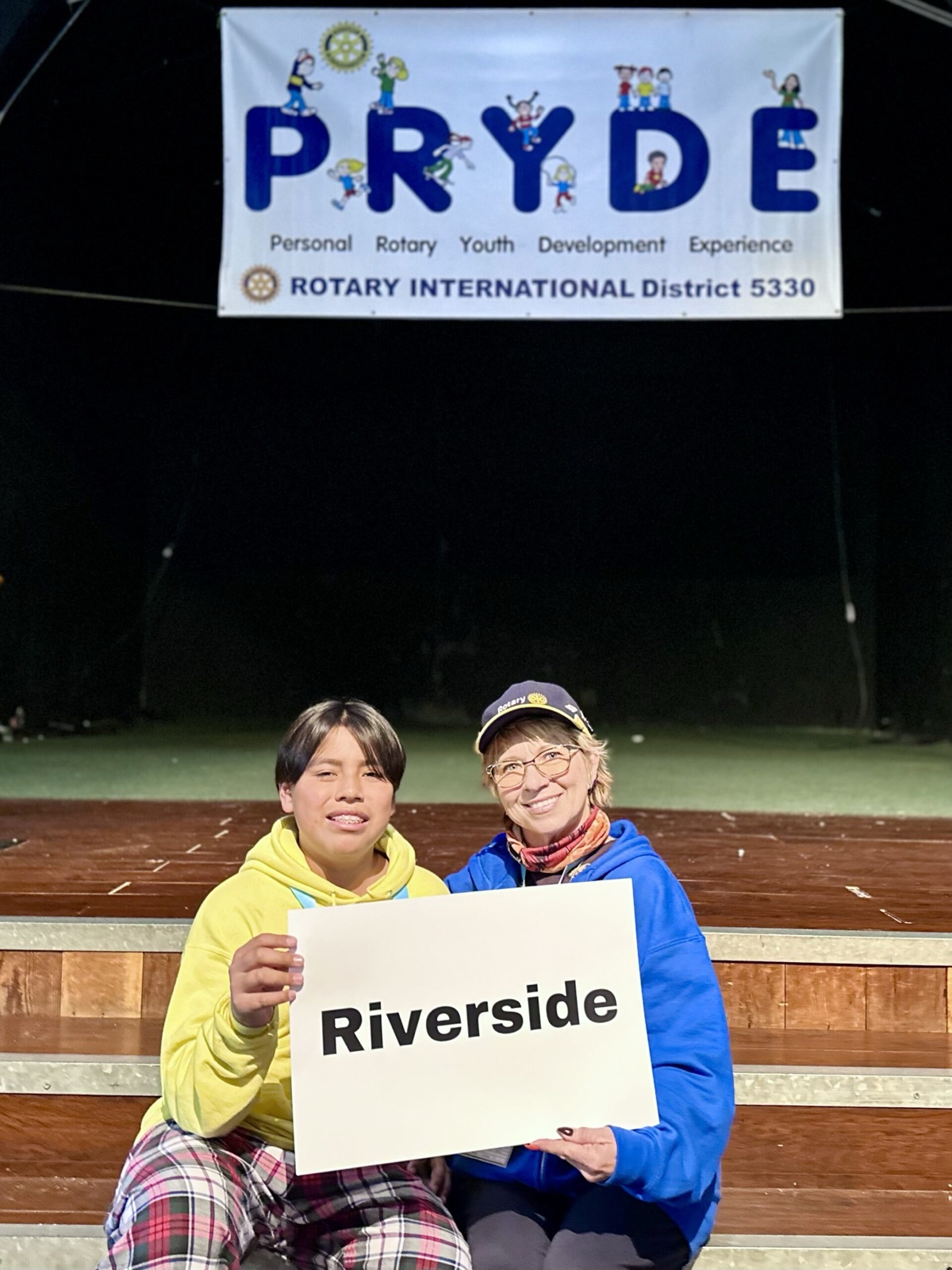 A sponsoring club's students at PRYDE 2023, under the PRYDE banner