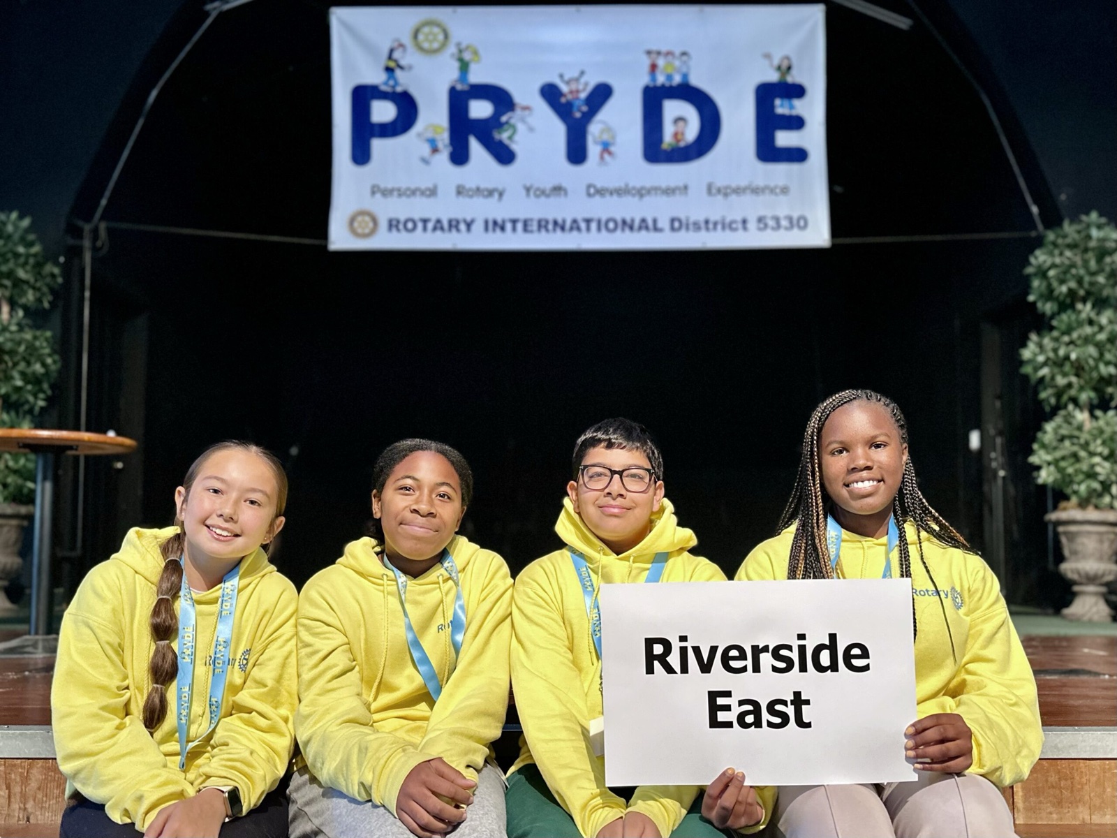 A sponsoring club's students at PRYDE 2023, under the PRYDE banner