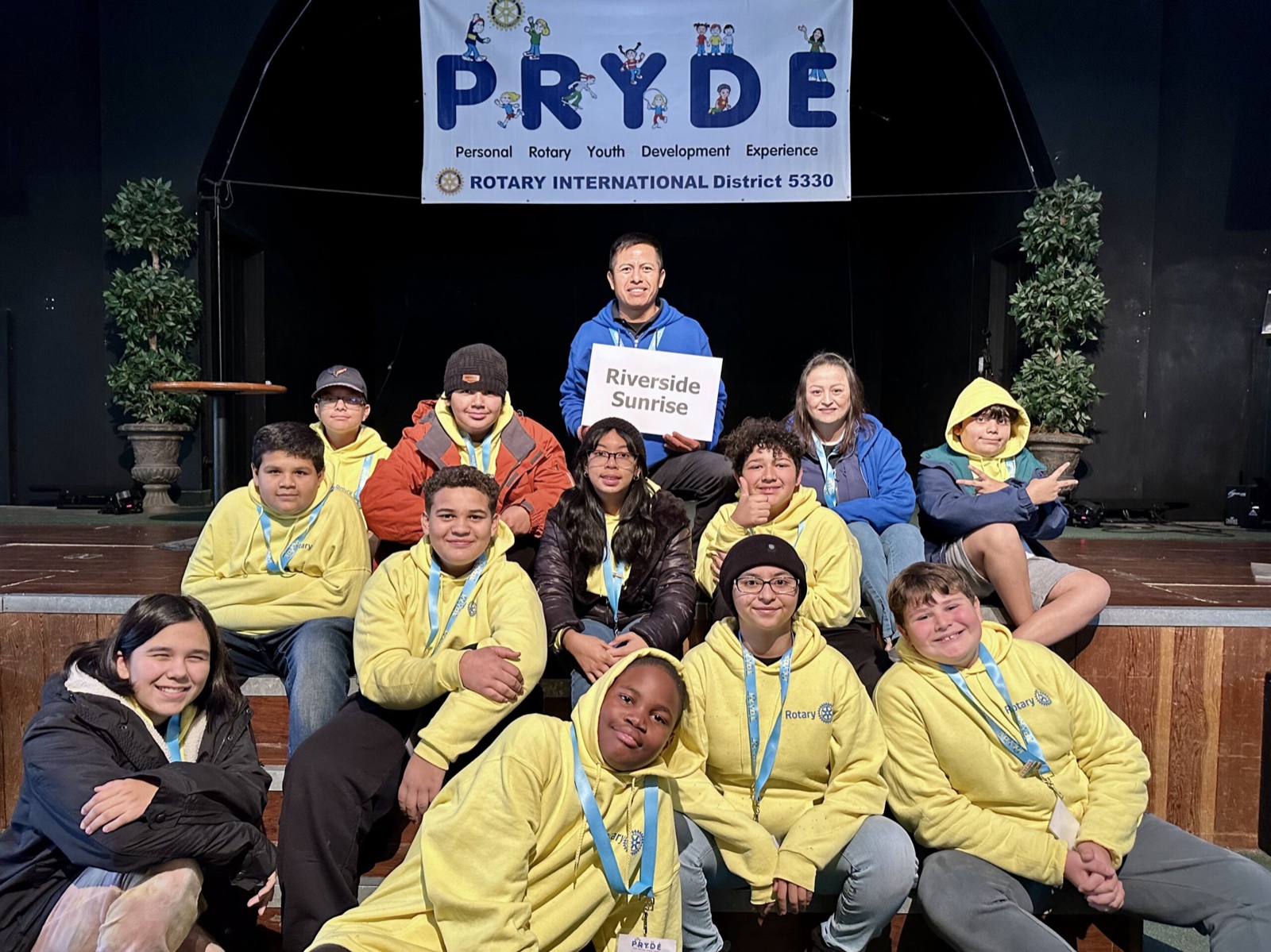 A sponsoring club's students at PRYDE 2023, under the PRYDE banner
