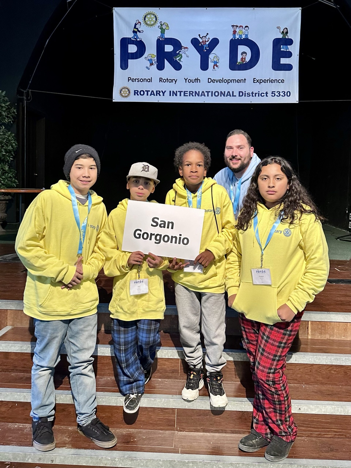 A sponsoring club's students at PRYDE 2023, under the PRYDE banner