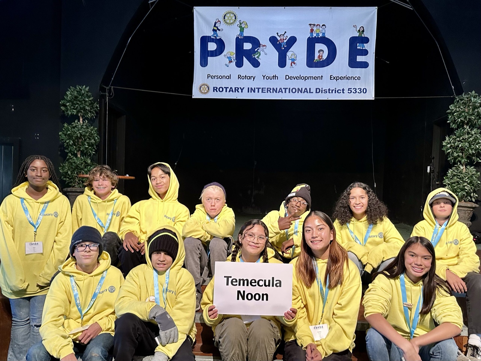 A sponsoring club's students at PRYDE 2023, under the PRYDE banner