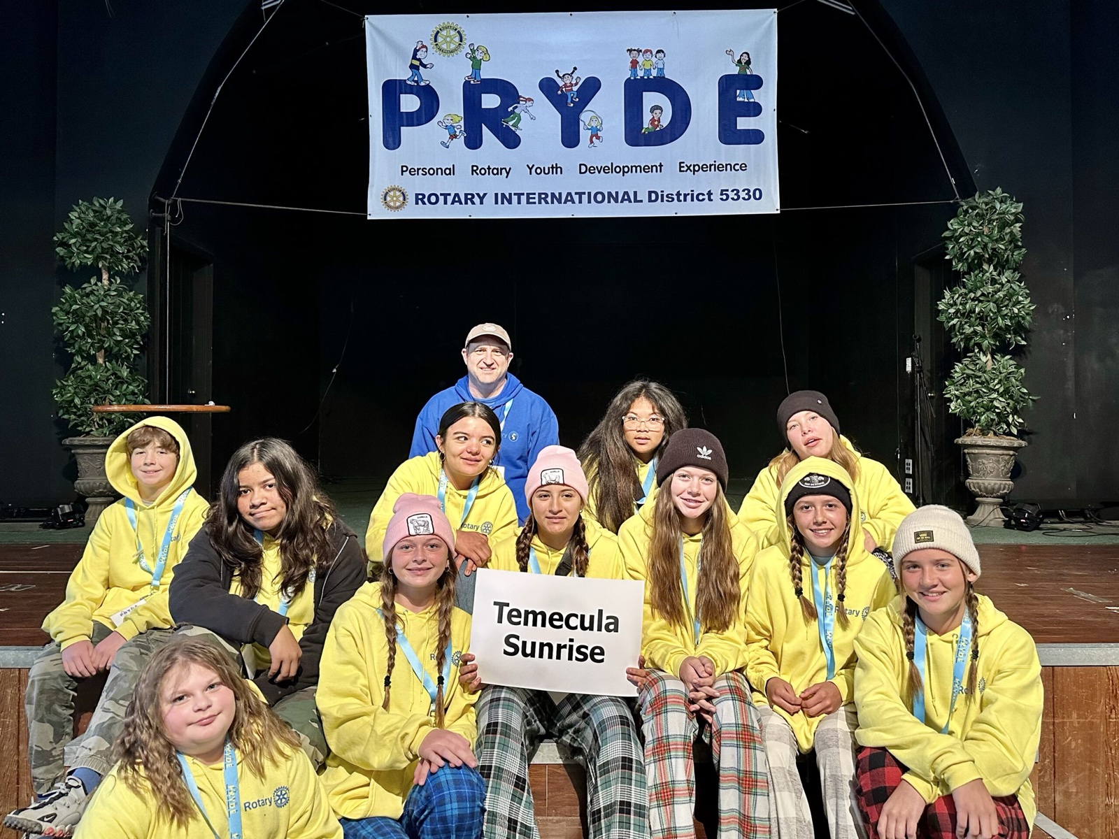 A sponsoring club's students at PRYDE 2023, under the PRYDE banner