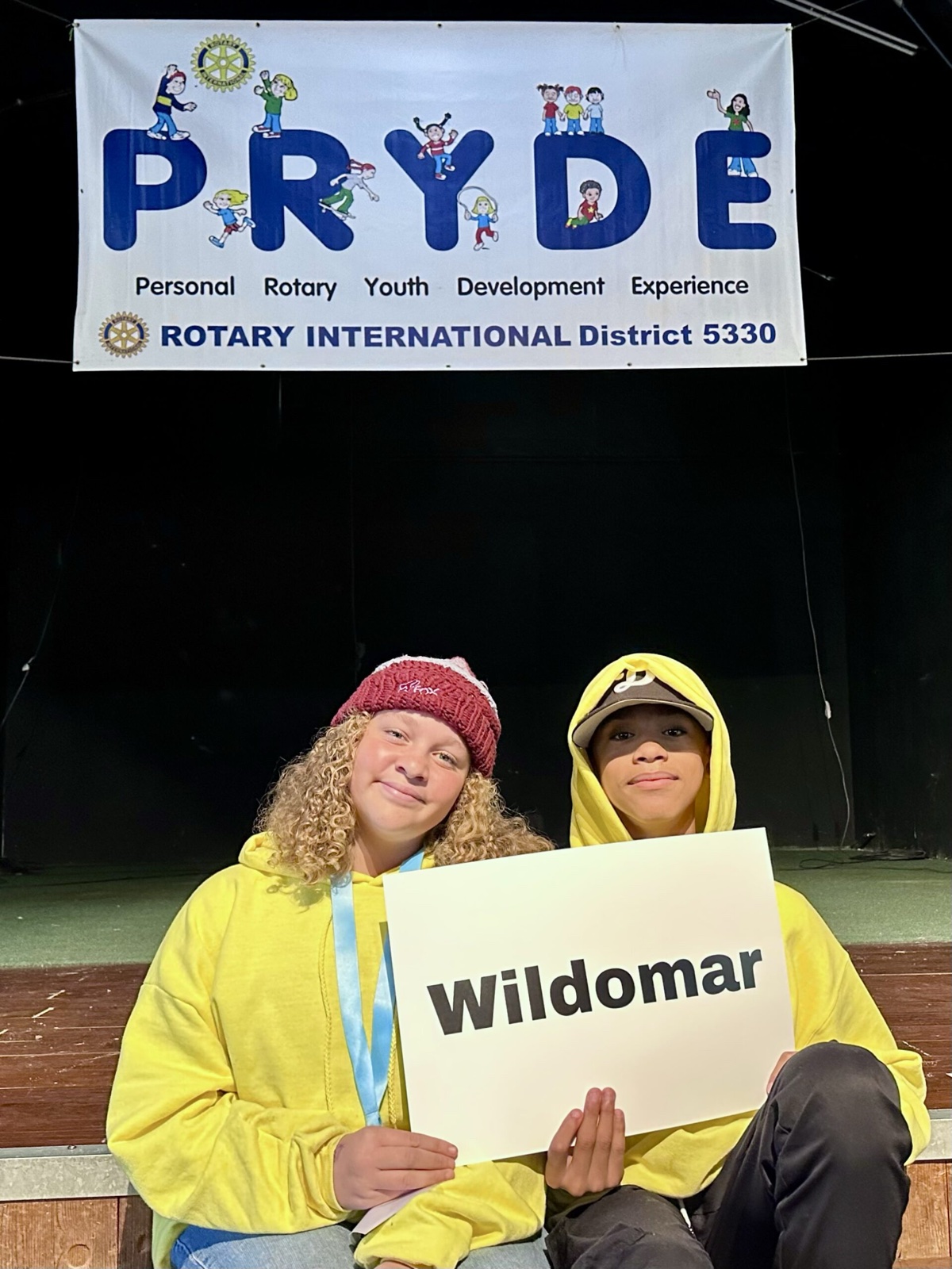 A sponsoring club's students at PRYDE 2023, under the PRYDE banner