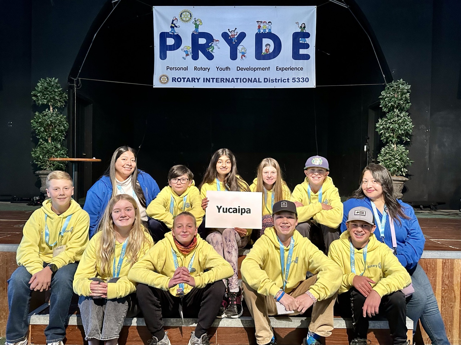 A sponsoring club's students at PRYDE 2023, under the PRYDE banner