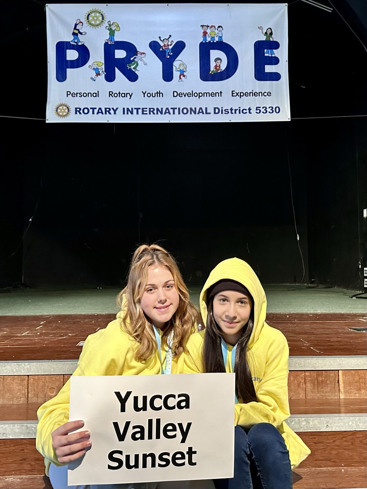 A sponsoring club's students at PRYDE 2023, under the PRYDE banner