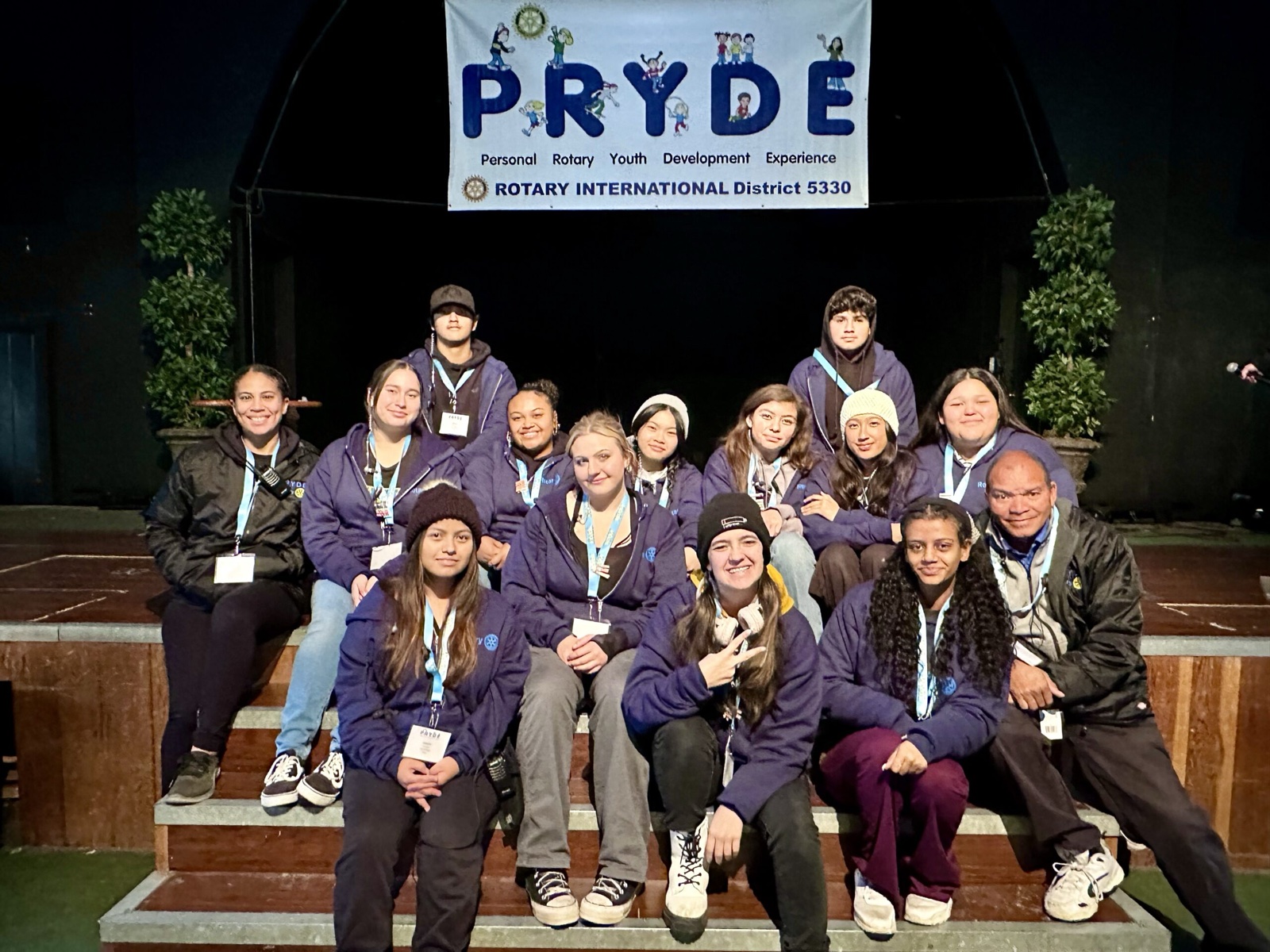 A sponsoring club's students at PRYDE 2023, under the PRYDE banner