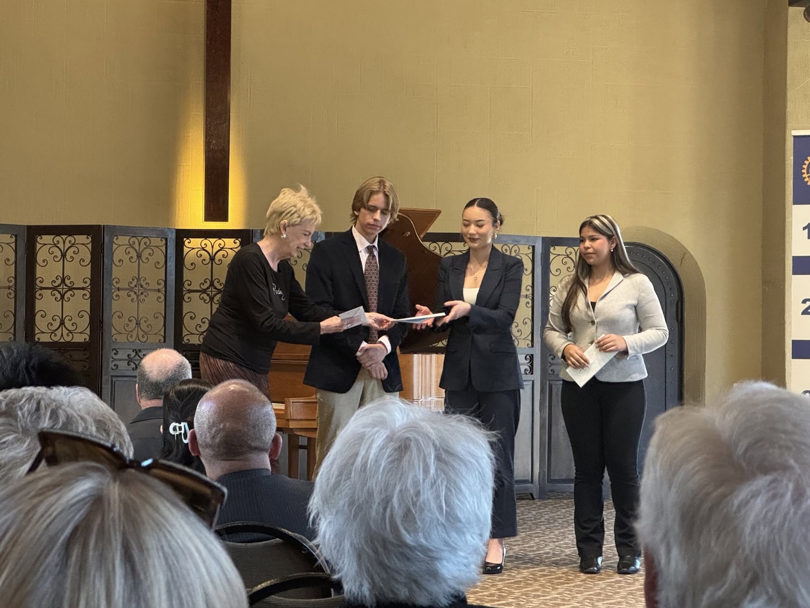 A Rotarian presents certificates to speech contestants at the RYSE showcase