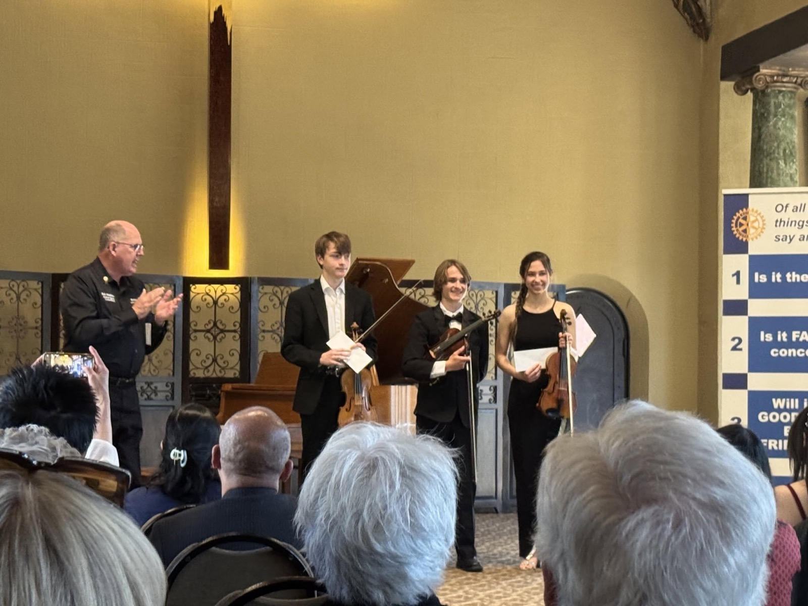 A student string trio is applauded after performing at the RYSE music competition