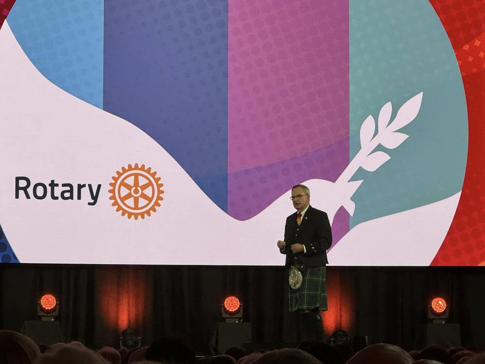 A speaker addresses a general session of the 2024 Rotary International Convention