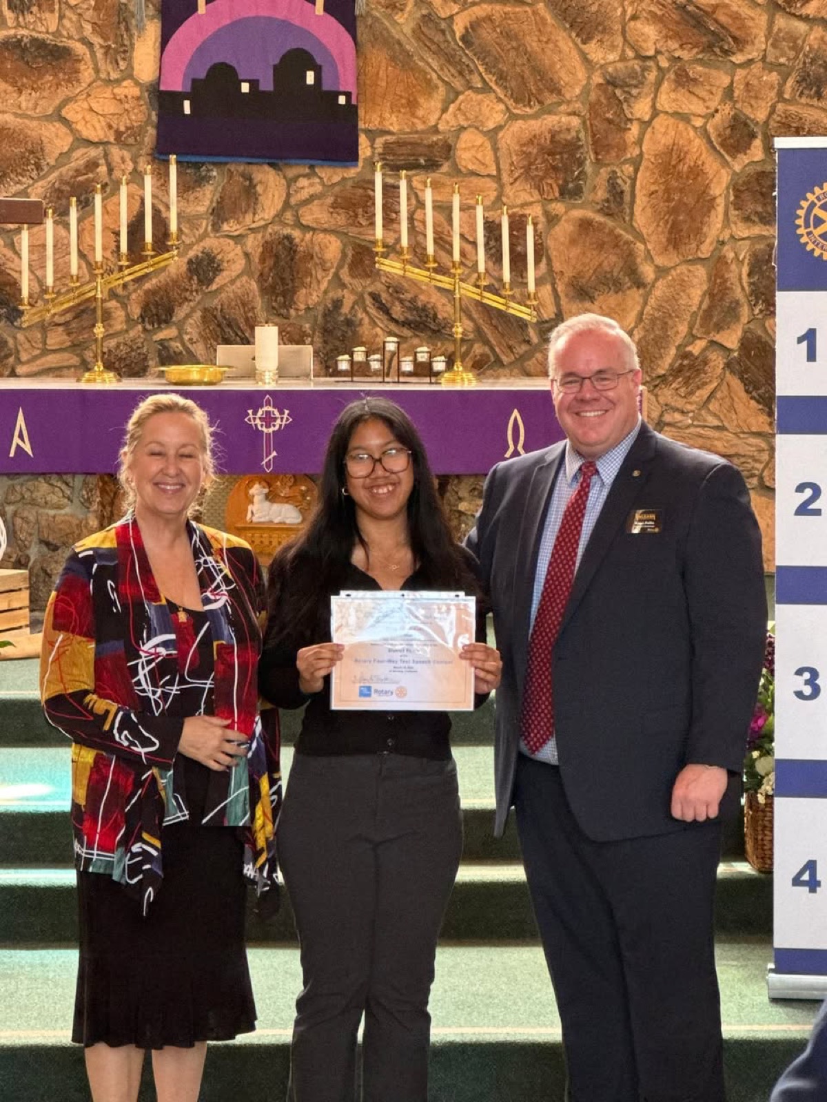 A contestant receives her certificate