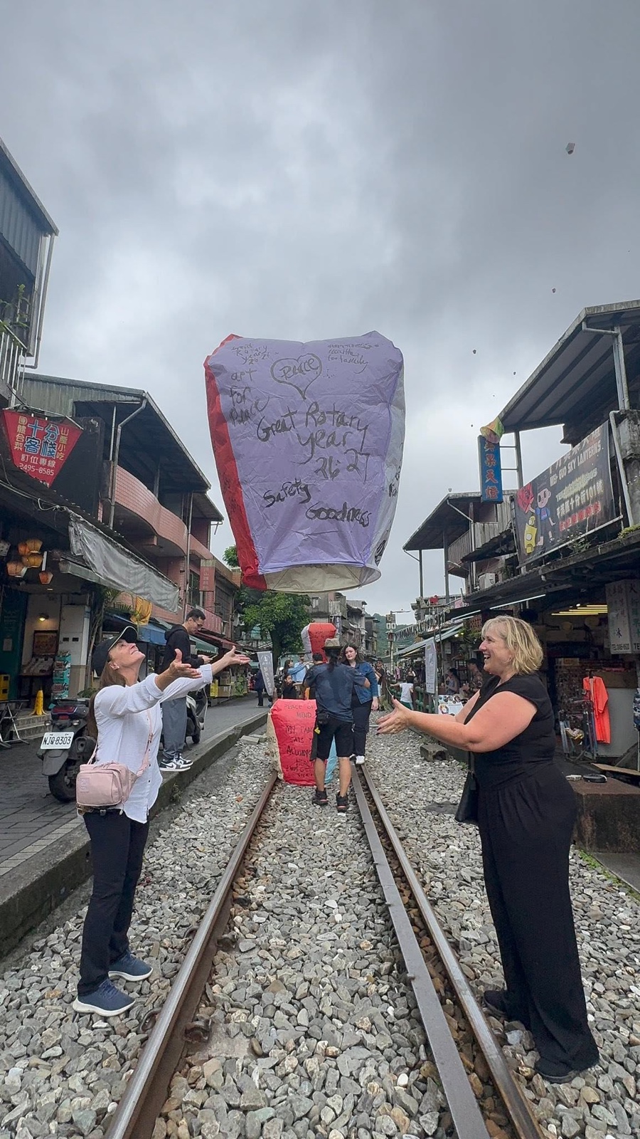 Releasing the District 5330 sky lantern over the Shifen railway tracks