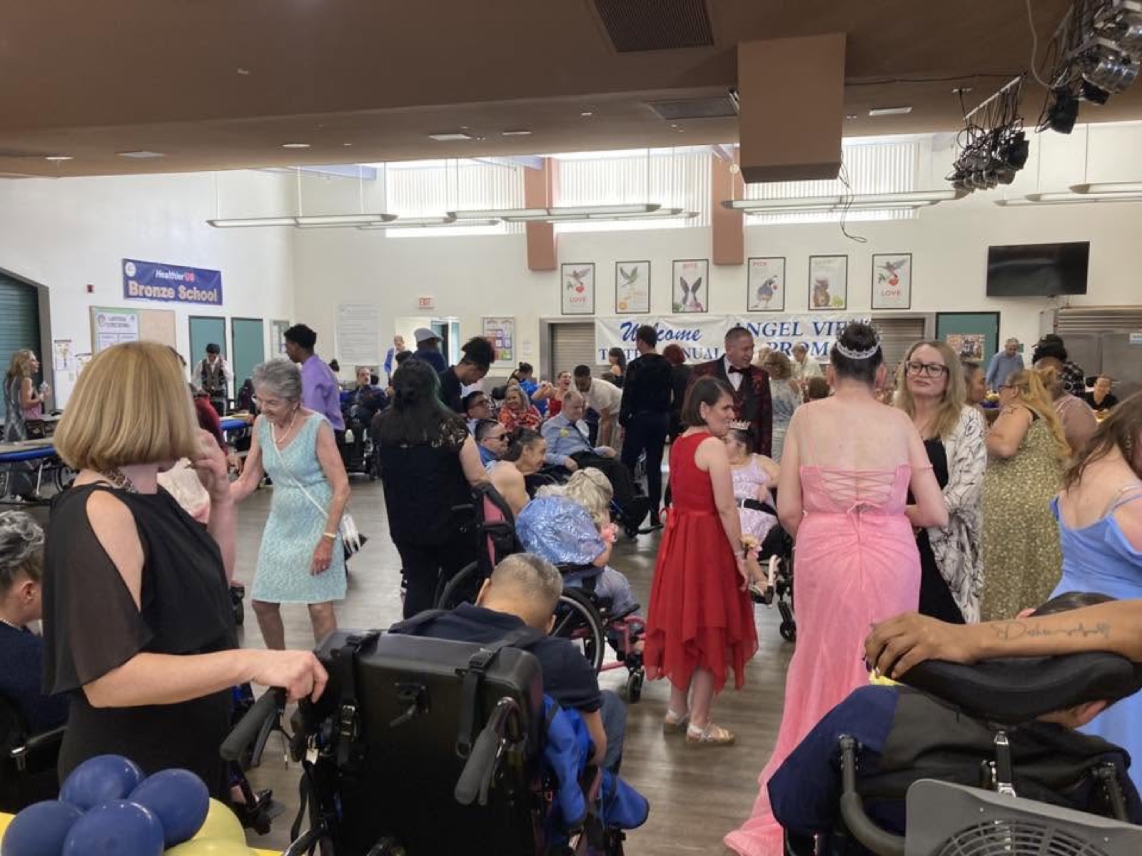 Community members, including people who use wheelchairs, celebrating at an accessible prom
