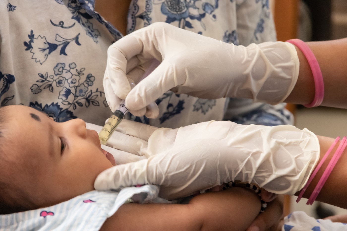 Infant receiving oral polio vaccine drops