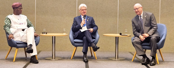 Yinka Babalola, Francesco Arezzo and Larry Lunsford seated in armchairs on stage during a panel session